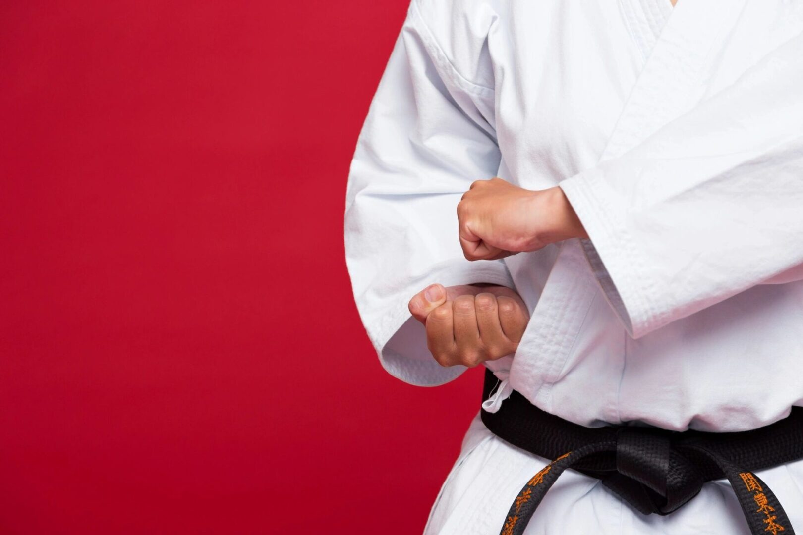 A person in white shirt and black belt