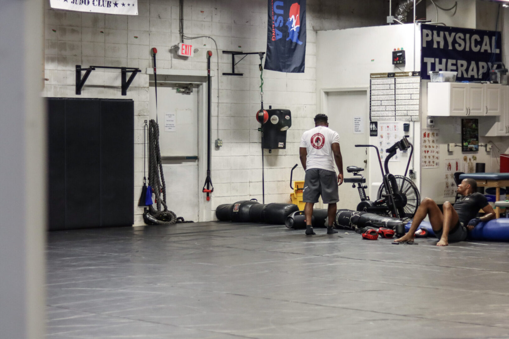 A man standing in the middle of an indoor gym.